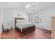 Bedroom with dark wood floors, large bed, vaulted ceiling and bright window at 11507 Rabbit Ridge Rd, Charlotte, NC 28270