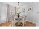Cozy dining area with a round table, four chairs, natural light, and modern light fixture at 11507 Rabbit Ridge Rd, Charlotte, NC 28270