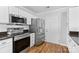 Well-equipped kitchen featuring stainless steel appliances, granite countertops, and white cabinets at 11507 Rabbit Ridge Rd, Charlotte, NC 28270