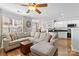 Bright, open-concept living room with a large sectional sofa, hardwood floors and open view of kitchen at 11507 Rabbit Ridge Rd, Charlotte, NC 28270