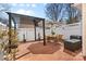 Outdoor patio with a modern pergola, brick flooring, and a dining set at 11507 Rabbit Ridge Rd, Charlotte, NC 28270