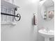 Stylish powder room with white pedestal sink and decorative towel rack at 11507 Rabbit Ridge Rd, Charlotte, NC 28270