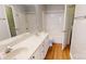 Bathroom with a dual sink vanity and a shower and tub combo with a shower curtain at 11630 Retriever Way, Charlotte, NC 28269