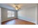 Well-lit bedroom with laminate flooring, a ceiling fan, and a large window at 11630 Retriever Way, Charlotte, NC 28269