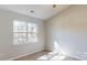 Sun-filled bedroom with large window, neutral walls, and carpeted flooring at 11630 Retriever Way, Charlotte, NC 28269