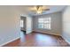 Bedroom featuring wood floors, a ceiling fan, and natural light from the windows at 11630 Retriever Way, Charlotte, NC 28269