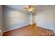 Bedroom with ceiling fan and wood-look flooring, bathed in natural light at 11630 Retriever Way, Charlotte, NC 28269