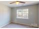 Bedroom featuring carpeted flooring, a ceiling fan and a large window with a pleasant view at 11630 Retriever Way, Charlotte, NC 28269