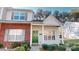 Attractive townhome with a brick accent, bright green door, and manicured bushes at 11630 Retriever Way, Charlotte, NC 28269