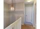 Hallway featuring carpet floors, a hanging light fixture, and doors at 11630 Retriever Way, Charlotte, NC 28269
