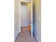 Hallway with neutral carpet leading to a closet for ample storage at 11630 Retriever Way, Charlotte, NC 28269