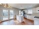 An open-concept kitchen with stainless steel appliances and access to the backyard through glass doors at 11630 Retriever Way, Charlotte, NC 28269