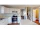 Spacious kitchen featuring white cabinets, stainless steel appliances, and access to the stairs at 11630 Retriever Way, Charlotte, NC 28269