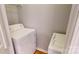 Laundry area with a white washer and dryer setup and wire shelving at 11630 Retriever Way, Charlotte, NC 28269