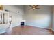 Open-concept living room featuring a fireplace, high ceiling, and wood-look flooring at 11630 Retriever Way, Charlotte, NC 28269