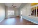 Living room with tall ceilings, wood floors, large windows, and staircase with railing at 11630 Retriever Way, Charlotte, NC 28269