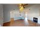 Spacious living room with a fireplace, vaulted ceiling, wood-look flooring, and access to stairs at 11630 Retriever Way, Charlotte, NC 28269