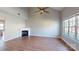 Bright living room boasts a fireplace, ceiling fan, and wood-look flooring at 11630 Retriever Way, Charlotte, NC 28269