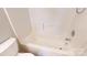 Bright white bathroom featuring a shower and tub combo with tiled walls and flooring at 11630 Retriever Way, Charlotte, NC 28269