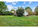 Spacious backyard featuring a lush green lawn, mature landscaping, and ample space for outdoor activities at 1214 Foxfield Rd, Waxhaw, NC 28173