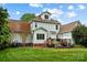 Beautiful backyard with lush green lawn, wooden deck, mature trees, and attractive two story home exterior at 1214 Foxfield Rd, Waxhaw, NC 28173