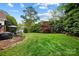 Lush green backyard showcasing a well-maintained lawn, mature trees, and a serene outdoor space at 1214 Foxfield Rd, Waxhaw, NC 28173