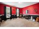 A red music room featuring instruments, black trim, and a window for natural light at 1214 Foxfield Rd, Waxhaw, NC 28173