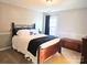 Bedroom featuring a queen-sized bed with dark wood frame, carpet, and neutral wall colors at 1214 Foxfield Rd, Waxhaw, NC 28173