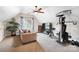 Multi-purpose bonus room with exercise equipment, a comfortable couch, and natural light from the window at 1214 Foxfield Rd, Waxhaw, NC 28173