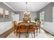 Elegant dining room features a classic chandelier, wainscoting, and ample seating for formal gatherings at 1214 Foxfield Rd, Waxhaw, NC 28173