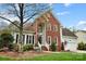 Beautiful two-story home showcasing brick and siding, a well-kept lawn, and an attached garage at 1214 Foxfield Rd, Waxhaw, NC 28173