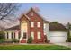 Charming two-story brick home with a well-manicured front yard, inviting entrance, and attached garage at 1214 Foxfield Rd, Waxhaw, NC 28173