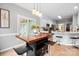 Eat-in kitchen with stylish table, pendant lighting, breakfast bar and seamless flow to other spaces at 1214 Foxfield Rd, Waxhaw, NC 28173