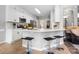 Bright kitchen featuring white cabinets, quartz countertops, and a breakfast bar with seating at 1214 Foxfield Rd, Waxhaw, NC 28173