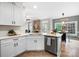 Bright kitchen with white cabinets, stainless steel appliances, and a view into the adjacent living room at 1214 Foxfield Rd, Waxhaw, NC 28173