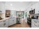 Modern kitchen with white cabinets, stainless steel appliances, and an open layout to the dining room at 1214 Foxfield Rd, Waxhaw, NC 28173