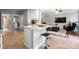 Open-concept kitchen with a central island, bar stool seating, and seamless transition to the living area at 1214 Foxfield Rd, Waxhaw, NC 28173