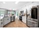 Contemporary kitchen with stainless steel appliances, white cabinets, and a window offering natural light at 1214 Foxfield Rd, Waxhaw, NC 28173
