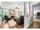 Comfortable living room with a fireplace, cozy seating, and an open view into the adjacent kitchen area at 1214 Foxfield Rd, Waxhaw, NC 28173