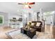 Open-concept living space with kitchen view, leather furniture and lots of natural light at 1214 Foxfield Rd, Waxhaw, NC 28173