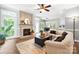 Cozy living room featuring a decorative fireplace, mantel, and view to kitchen, perfect for entertaining at 1214 Foxfield Rd, Waxhaw, NC 28173