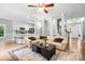 Bright living room features a neutral color palette, plush sofa, and seamless open-concept design to the kitchen at 1214 Foxfield Rd, Waxhaw, NC 28173