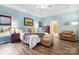 Serene main bedroom with a tray ceiling, hardwood floors, and an ensuite bathroom, creating a tranquil retreat at 1214 Foxfield Rd, Waxhaw, NC 28173
