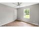 Bright bedroom features a ceiling fan and a window overlooking the backyard at 1320 Beaconfield Ct, Rock Hill, SC 29730