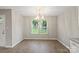 Dining room featuring chandelier, wood floors and natural light at 1320 Beaconfield Ct, Rock Hill, SC 29730