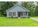 Charming single-story home with a well-manicured lawn, dark shutters, and inviting front porch at 1320 Beaconfield Ct, Rock Hill, SC 29730