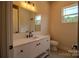 An elegant bathroom with white cabinetry, a quartz countertop, and a modern faucet, complemented by a large mirror at 1429 Coppergate Dr, Salisbury, NC 28147