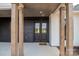 Inviting covered entryway featuring sturdy wooden pillars and stylish double doors, creating a warm welcome to the home at 1429 Coppergate Dr, Salisbury, NC 28147