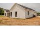 New construction home featuring white siding, black trim windows and a detached garage at 1429 Coppergate Dr, Salisbury, NC 28147