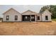 Charming single-story home with a covered porch, black accents and neutral siding, surrounded by a newly mulched lawn at 1429 Coppergate Dr, Salisbury, NC 28147